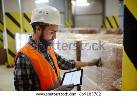 Dispatcher of storehouse looking for online data Royalty-Free Stock Photo #669185782