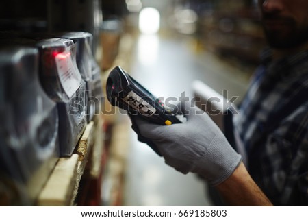 Scanning machine held by warehouse dispatcher Royalty-Free Stock Photo #669185803
