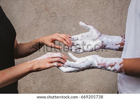 conceptual picture of two people of different races holding hands