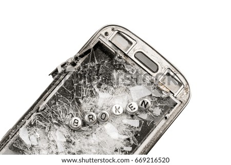 Old broken phone with the inscription BROKEN made of silver beads on white background. Isolated