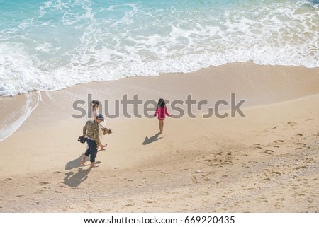 Groom and bride in a white dress on the beach
