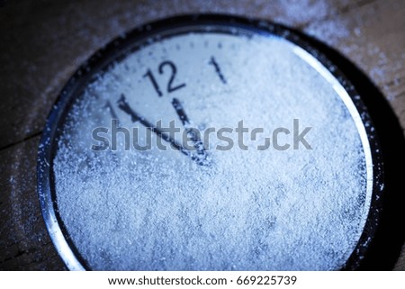 Clock in snow.