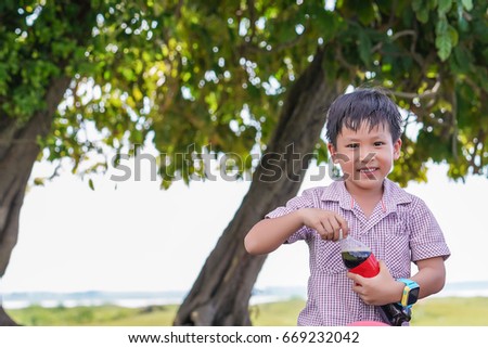 Cute boy holding bottle soda 