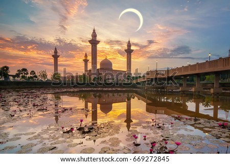 Tengku Ampuan Jemaah mosque, Bukit Jelutong Shah Alam during beautiful golden sunrise and crescent moot with reflection from the lake