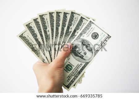 cash fan of dollars on white background