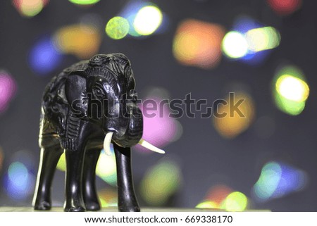 the black elephant doll and many color bokeh