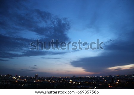 dark blue cloud with white light sky background and city light midnight evening time   Royalty-Free Stock Photo #669357586