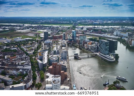 Looking at Media Harbor at Rhine-River in Dusseldorf in Germany / Media Harbor with Rhine-Tower and famous buildings from Frank Gehry / Cityscapes of Germany Royalty-Free Stock Photo #669376951