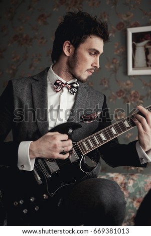 Musician in a suit with an electric guitar