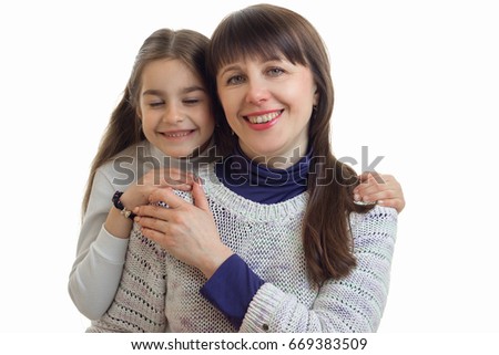 Portrait of a little daughter with smiling mother