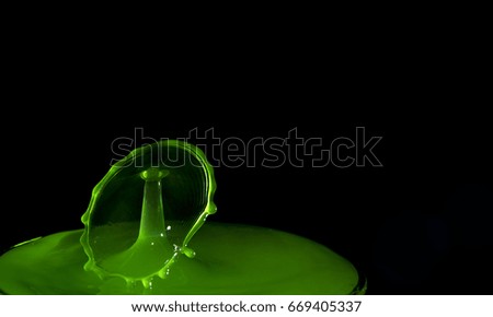Bouncing water drop in macro isolated over black background