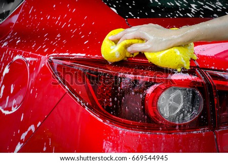 hands hold sponge for washing car Royalty-Free Stock Photo #669544945