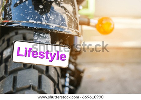 The small sign at the end of the motorcycle  indicates the lifestyle of motorbike owners.