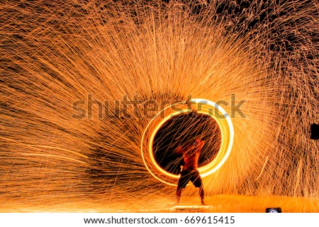 Fire dancers Swing fire dancing show fire show on the beach dance man juggling with fire , Koh Samet, Thailand Royalty-Free Stock Photo #669615415