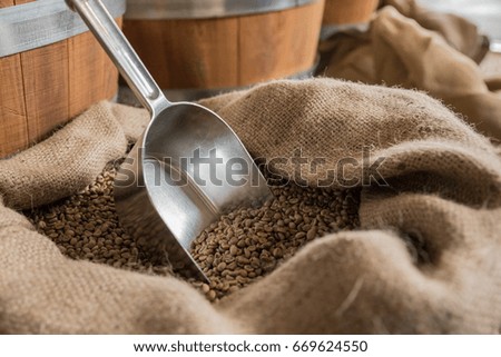 Sack with coffee beans and the metal scoop