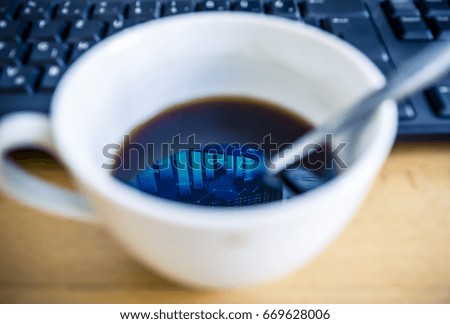 Stock exchange chart is reflected on the coffee surface, blurry keyboard in the background