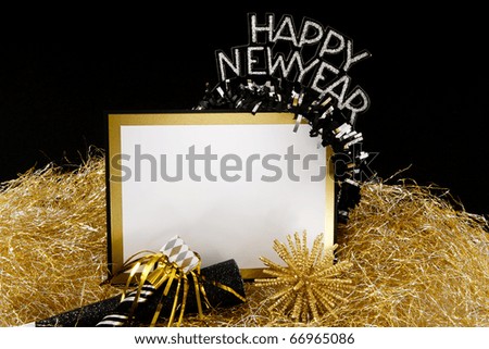Happy New Year sign or invitation with copy-space in black and gold with traditional party favors