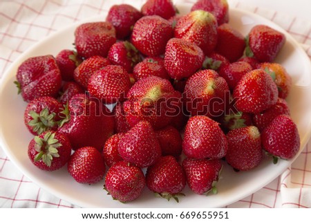 Fresh Ripe Red Strawberries on a White Plate with Crumpled Napkin Close-up Horizontal Top View Picture