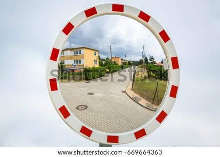Safety road mirror on the street in Poland