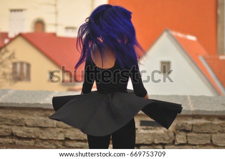 Girl with blue hair twisting around.