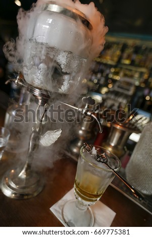 preparation of traditional absinthe in bar on old town of prague