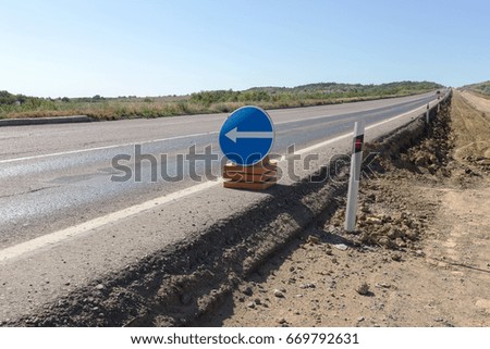 Road repair. Sign - arrow detour. There is no road, the road is closed, the road is repaired