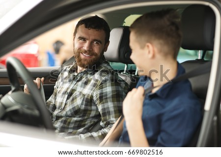 Shot of a young boy talking to his cheerful father sitting together in a new car driving travelling trip journey happiness lifestyle parent vehicle automobile rent safety insurance family parenting  Royalty-Free Stock Photo #669802516