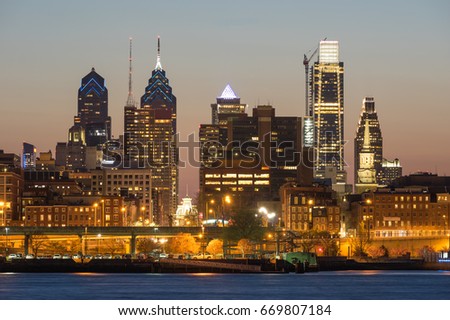 Philadelphia, Pennsylvania skyline at sunset. Deleware River in the foreground.