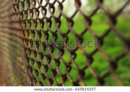 Metal mesh covered with rust. Old fence.