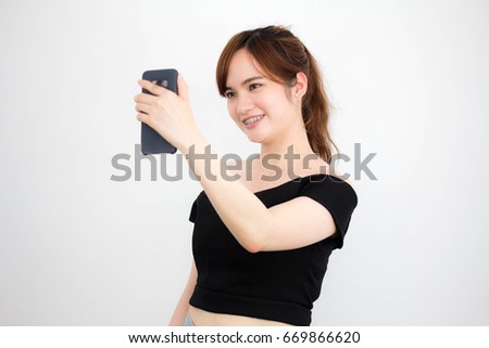Portrait of thai adult beautiful girl using her smart phone Selfie