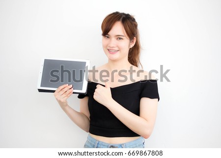 Portrait of thai adult beautiful girl using her tablet.