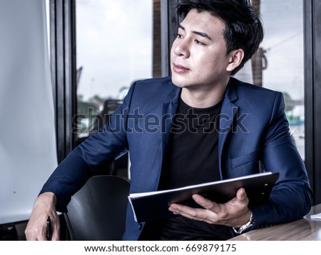 A picture of a businessman thinking about a new project.