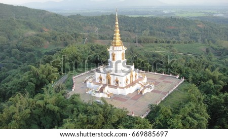 white temple on mountain,big tree in  rural scape