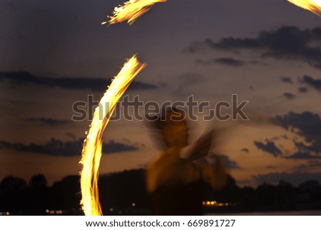 Fire Performer -  sunset fire dancing  at the beach