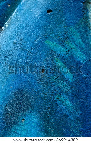 The old plastered brick wall wall with the remains of paint. Concrete, weathered, worn out wall is damaged by paint. Abstract background for creative design