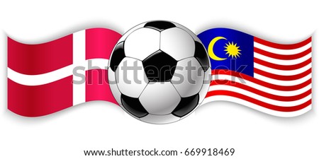 Danish and Malaysian wavy flags with football ball. Denmark combined with Malaysia isolated on white. Football match or international sport competition concept.