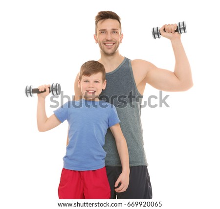 Happy dad and son with dumbbells in hands on white background