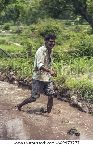 A young farmer doing preparation for rice planting.