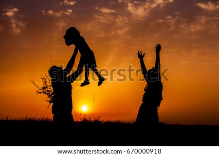 Family silhouettes in nature. We are happy family. silhouette of happy family father mother and son playing outdoors at sunset.