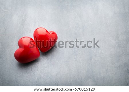 Hearts on the red color of the gray background.