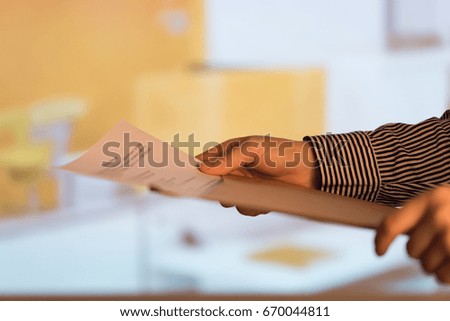 Woman checking papers at the office