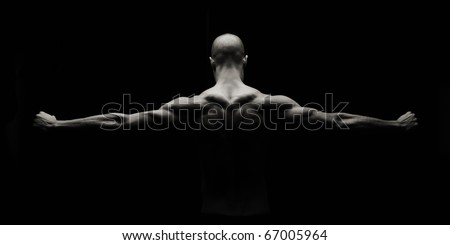 Low key artistic strong man on a black background Royalty-Free Stock Photo #67005964