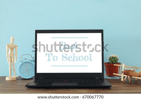 Image of office work place with open laptop and empty white screen for copy space