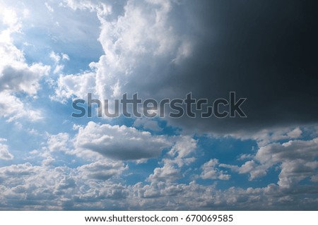 Blue sky with white clouds on sunset. Many little white clouds creating a tranquil weather pattern on the blue background