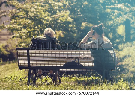 grandma and caregiver, the couple is sitting at the park (picture vintage effect)