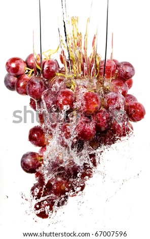 Grapes cluster in water splashes