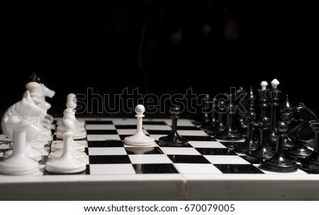 black and white chess on chessboard. move in chess a pawn E2 - E4