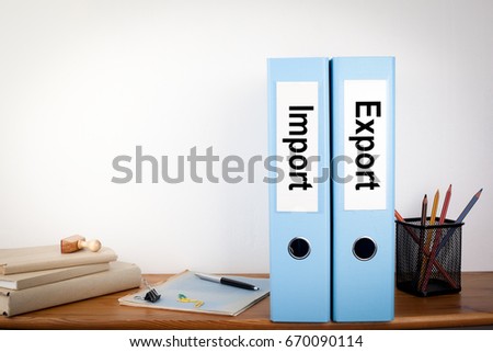 Import and Export binders in the office. Stationery on a wooden shelf