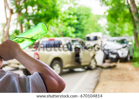 Man drinking beer ,car accident on the road as background.