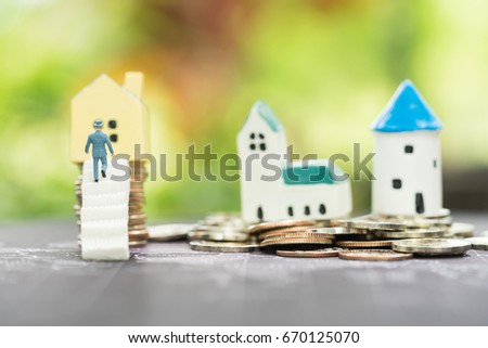 Miniature people: Miniature people walking on the ladder to house on coins stacks. Money, real estate, love and Valentine's day concepts.